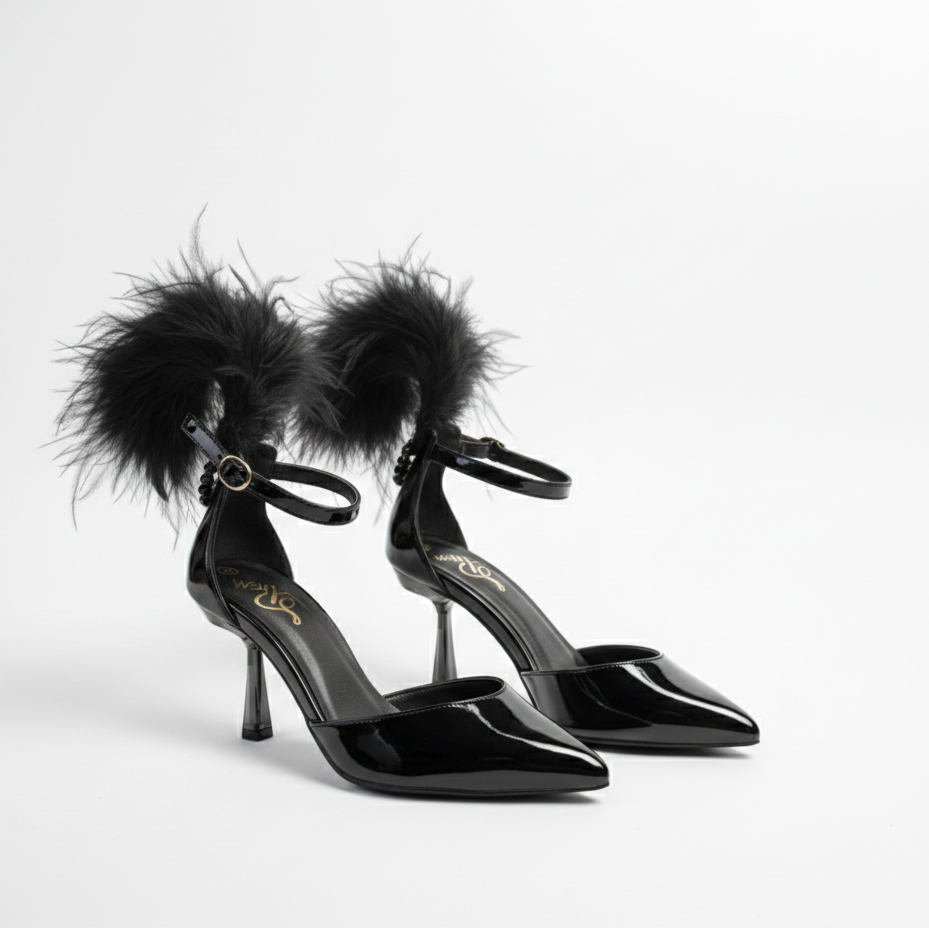 Black high-heeled shoes with feather details on a white background