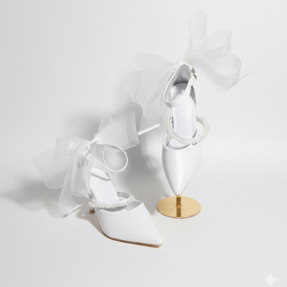 White high-heeled shoes with a gold sole on a white background