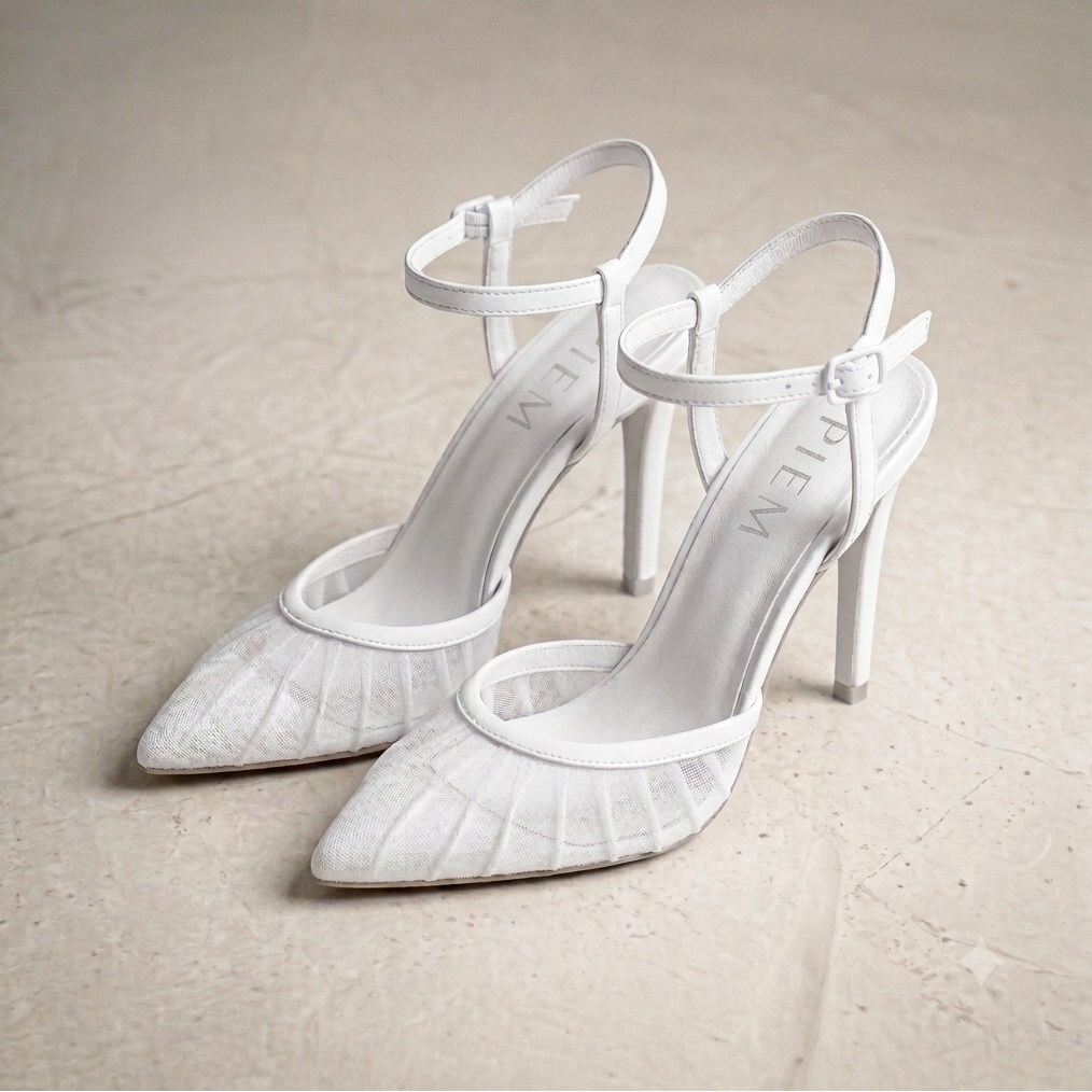 Pair of white high-heeled shoes on a beige background