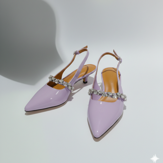 Pair of lavender high-heeled shoes with embellished straps on a light gray background