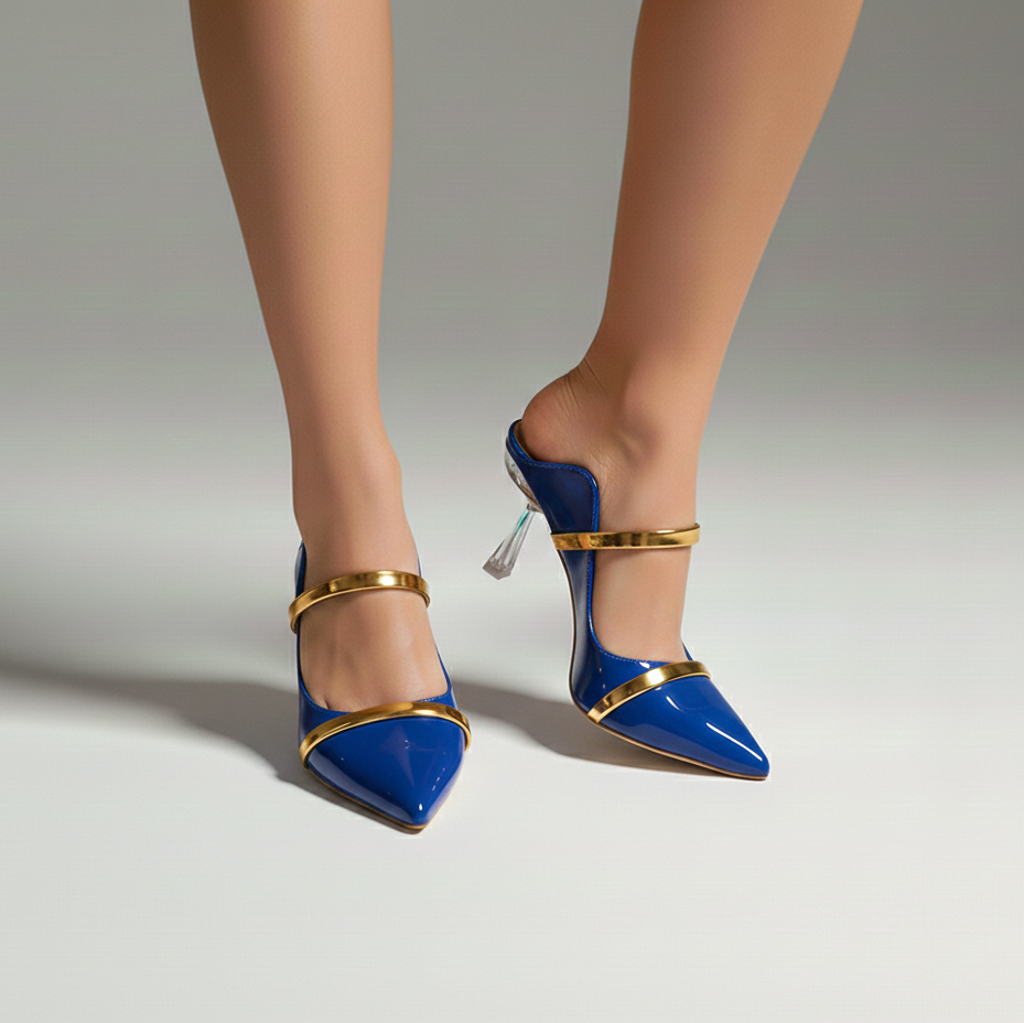Blue high-heeled shoes with gold accents worn by a person on a neutral background